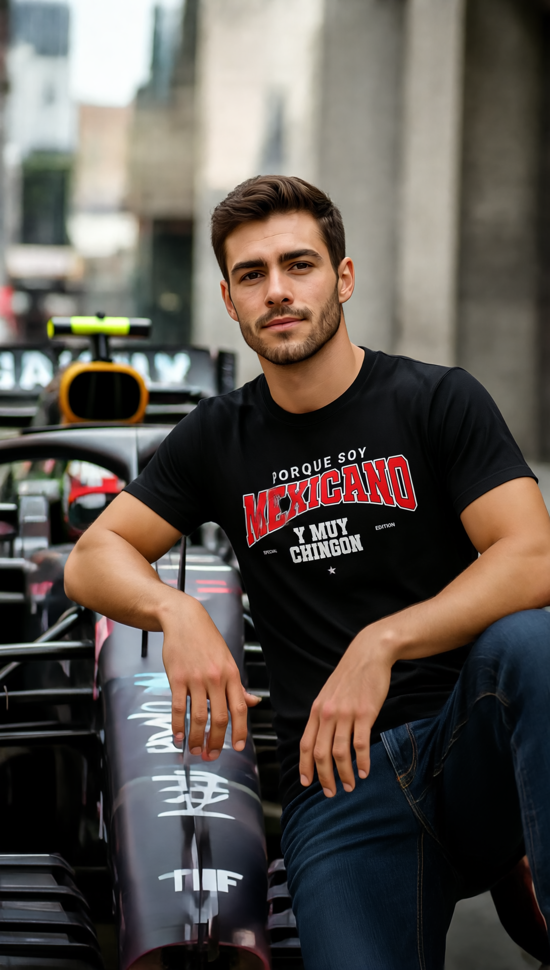 Man wearing KE CHINGÓN “Porque Soy Mexicano y Muy Chingón” T-shirt posing beside race car.